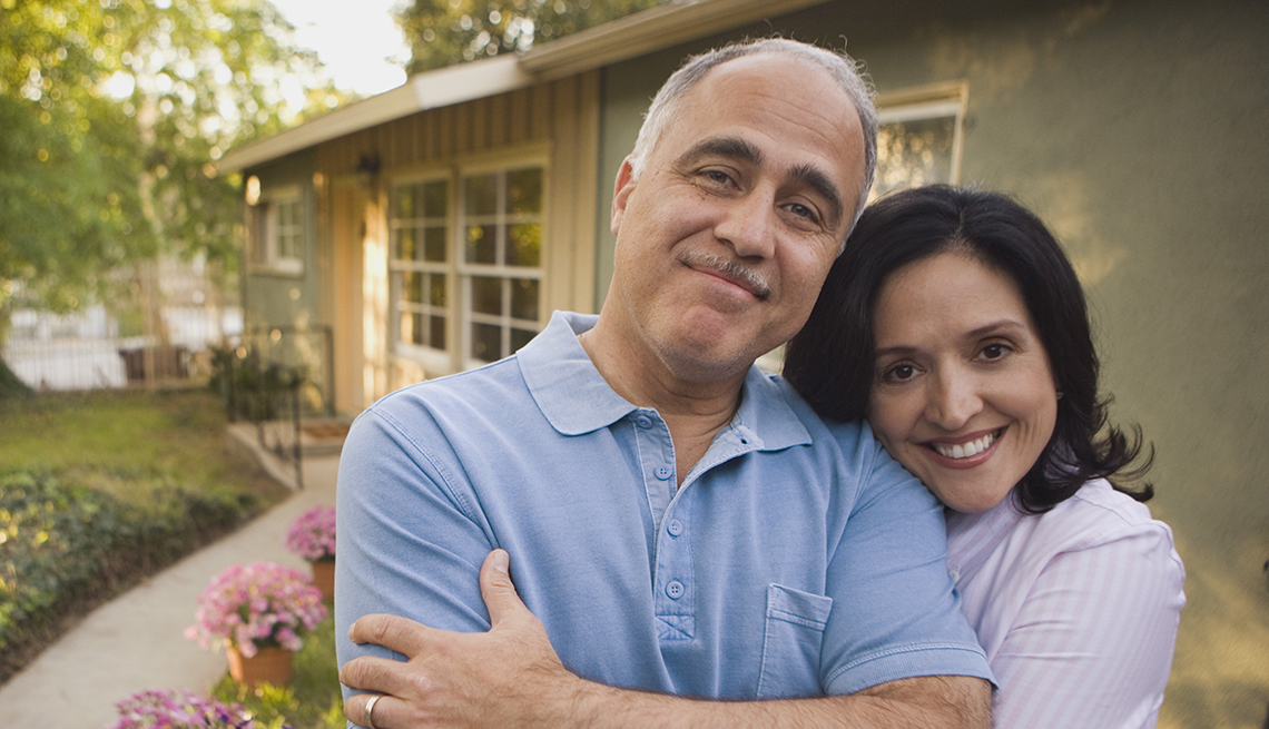 Couple hugging outside a house, AARP, Public Policy Institute, Issues, Work, Retirement