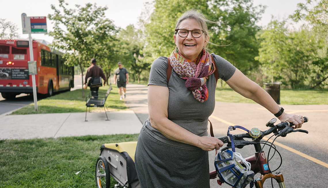 Robin Phillips holding her bicycle on a bike path