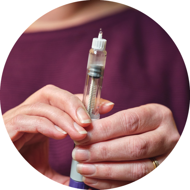 Photograph of hands holding a syringe