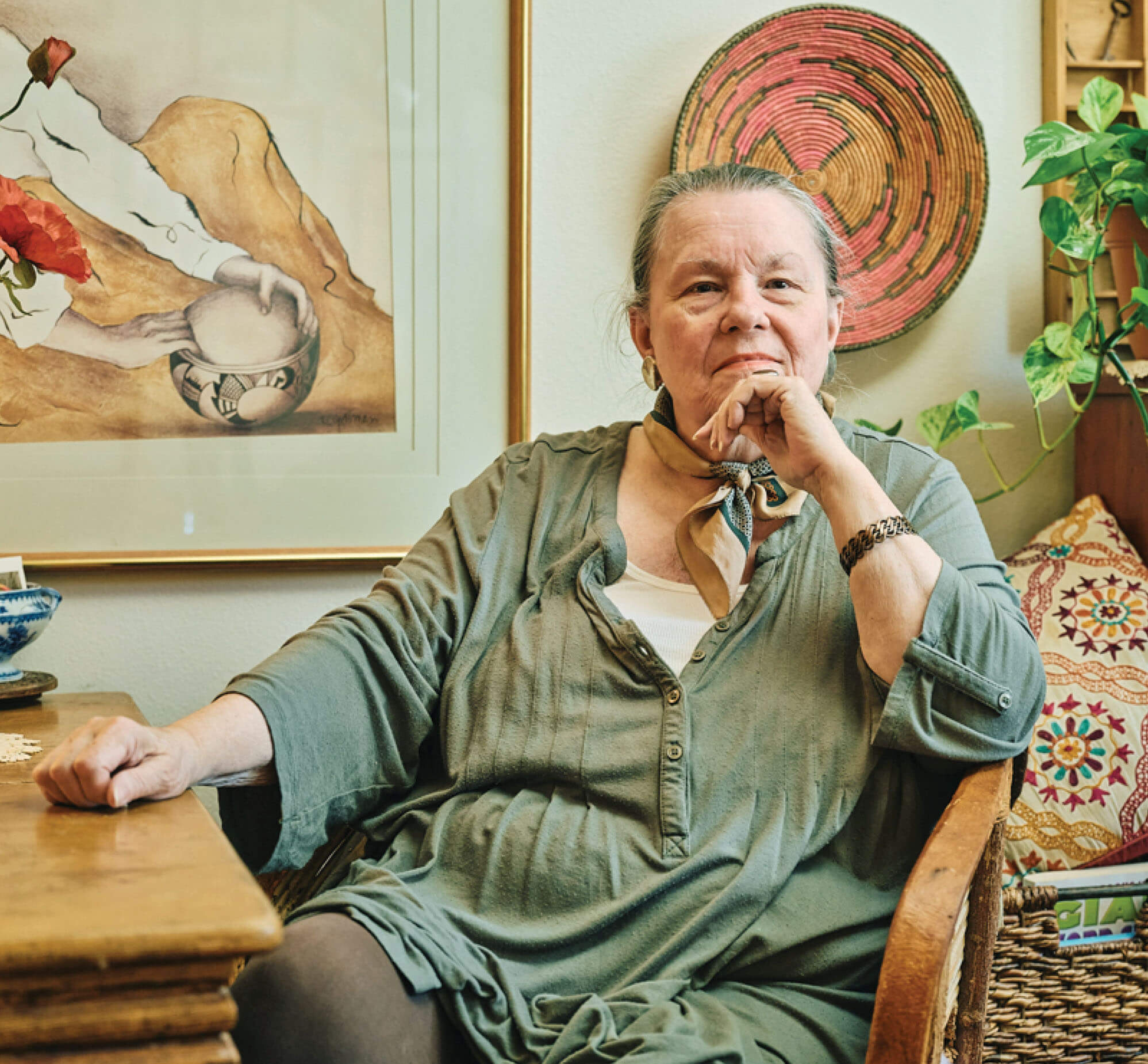 A caucasian woman, Carolyn Antell, sitting at a table with her hand on her chin