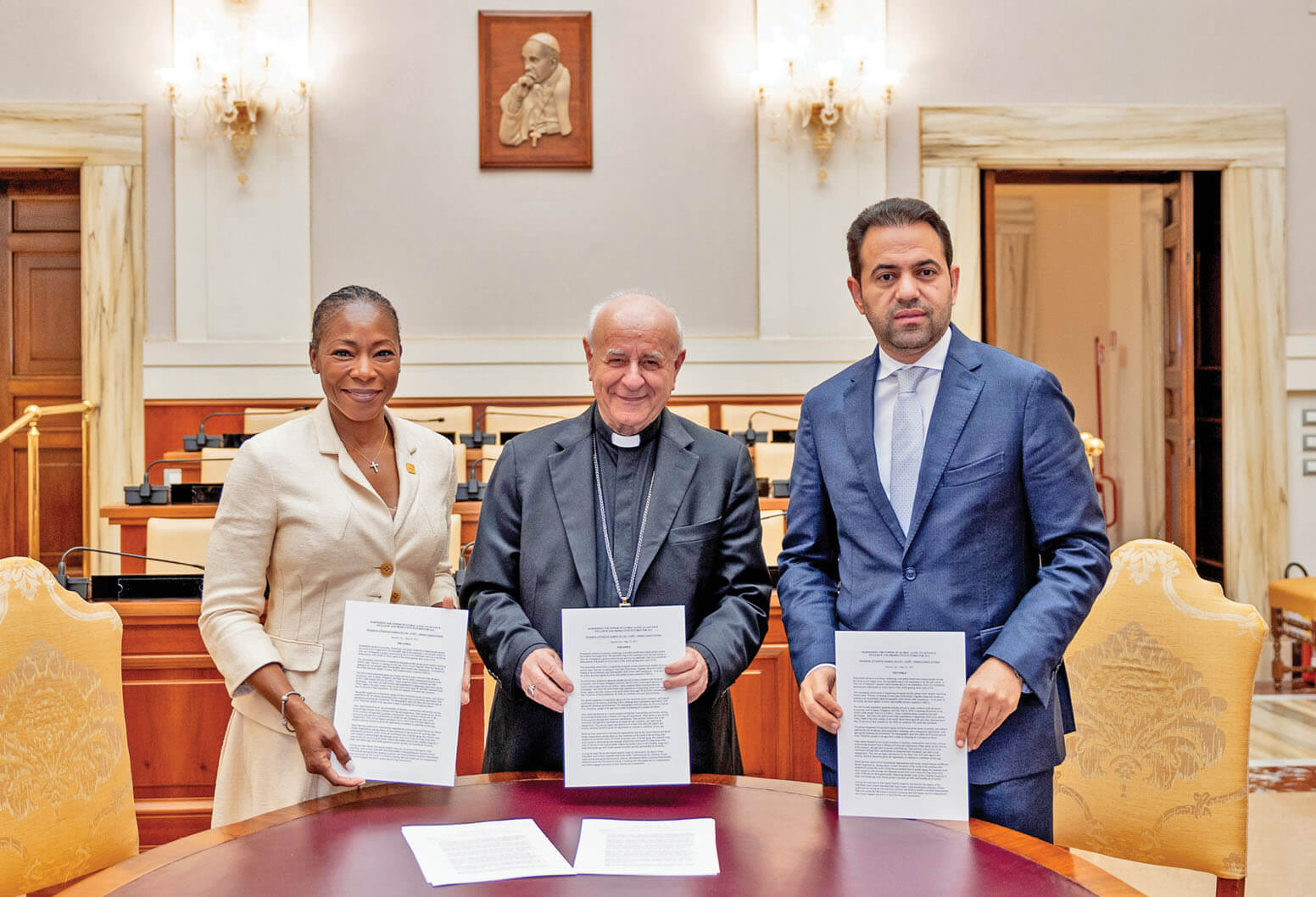Picture of 3 people in an elegant office, each displaying a document.