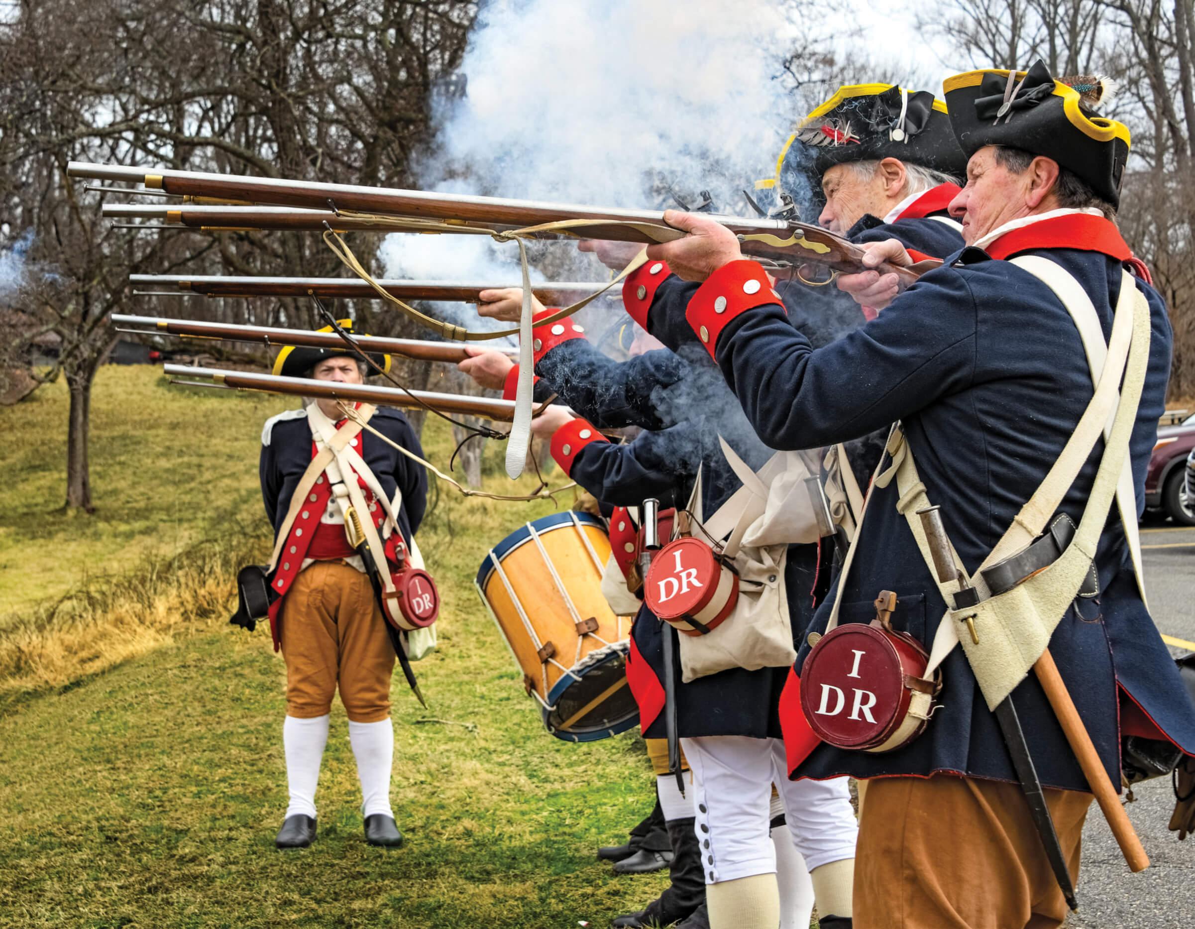 Photograph of reenactors of the 1st Delaware Regiment fire