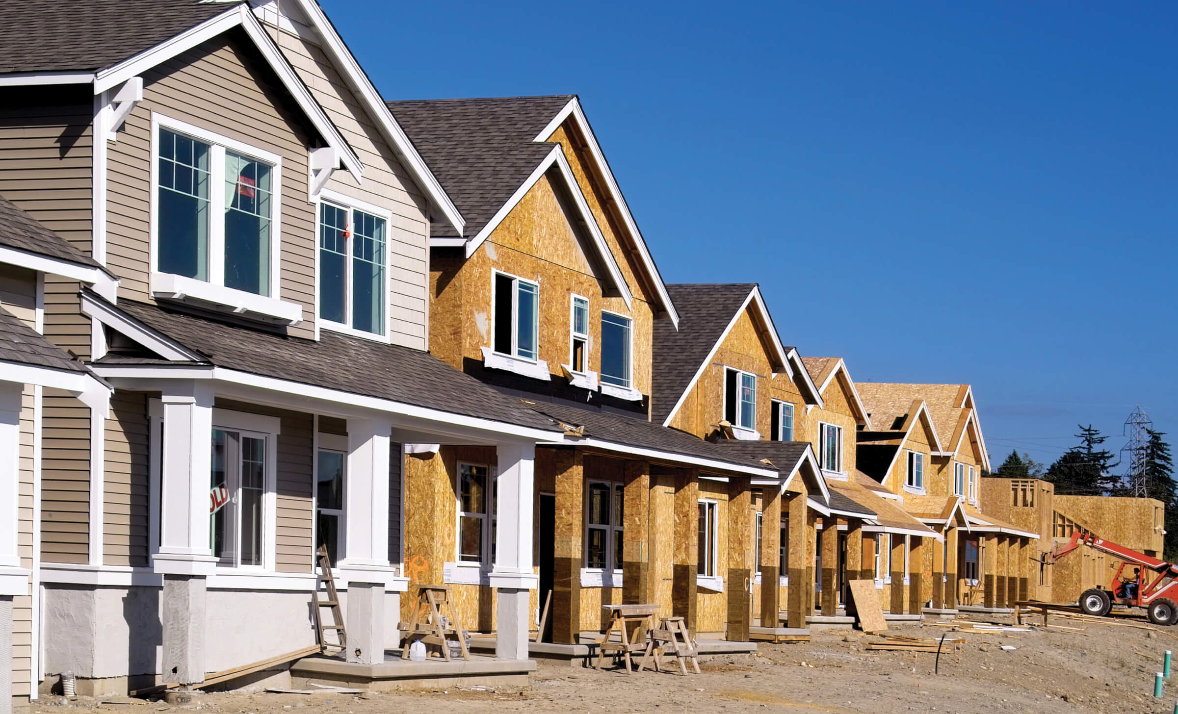 Photo of a row of houses being constructed