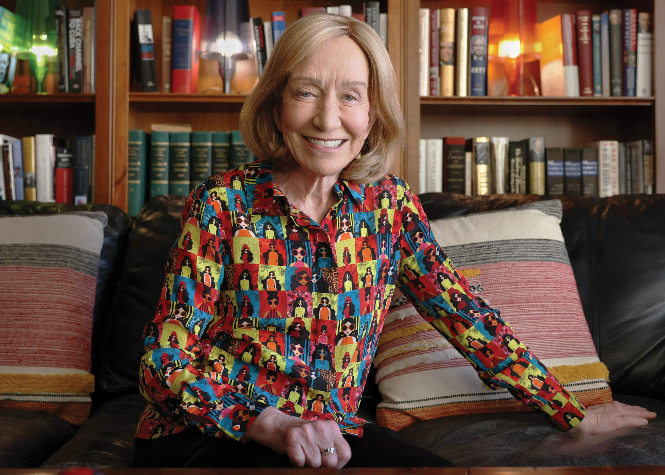 Portrait photograph of Doris Kearns Goodwin sitting on a couch in front of a bookcase