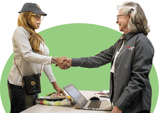 Image of an AARP Tax Aide Volunteer shaking a clients hand
