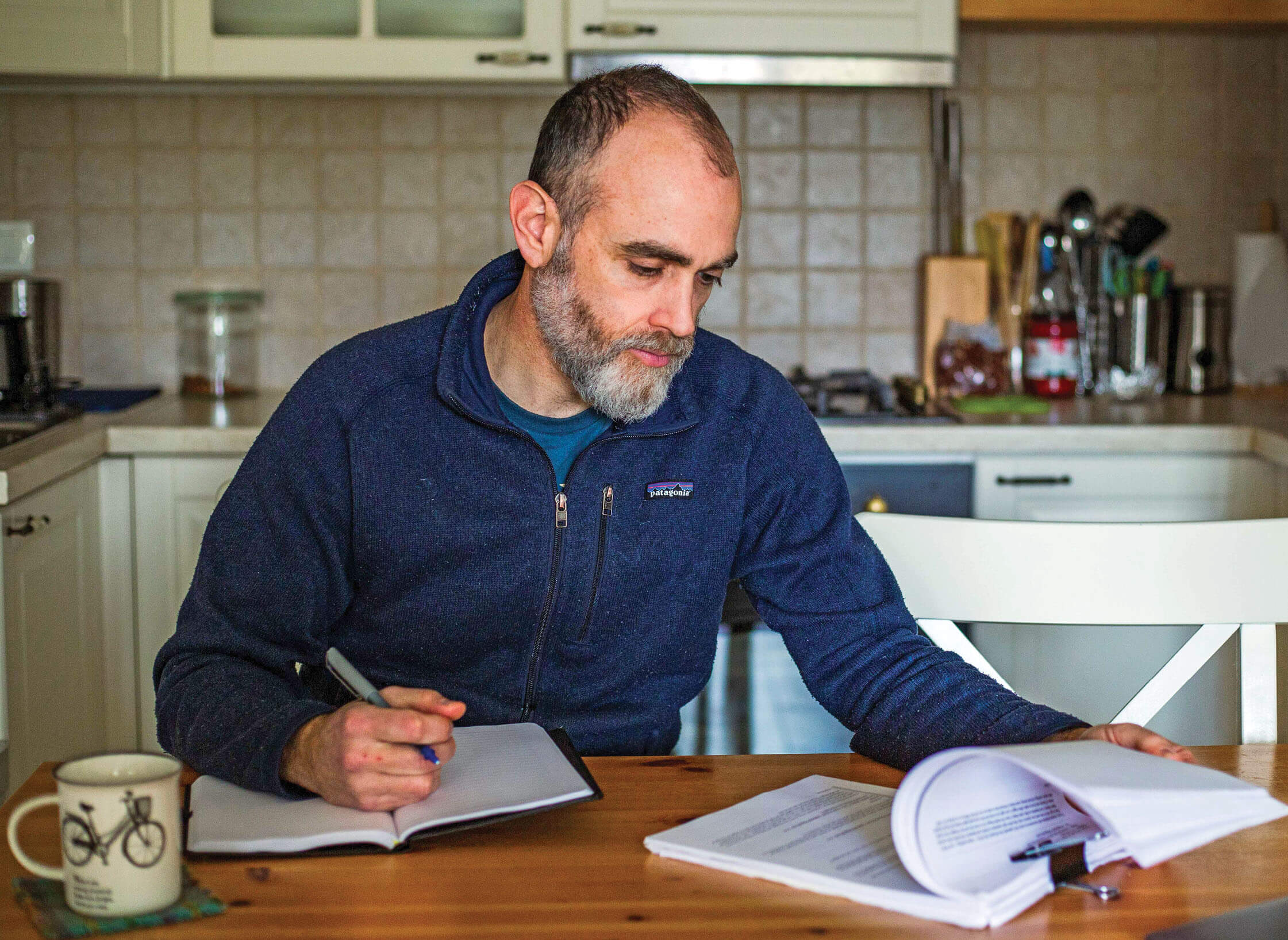 Photo of Rory Macleod at his kitchen table looking at paperwork