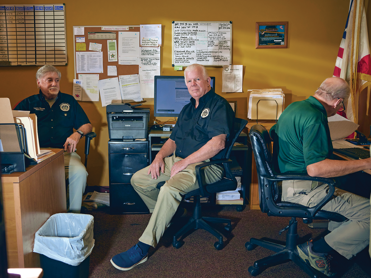 Photograph of Ed Kelly sitting along with 2 other men in an office space&nbsp;