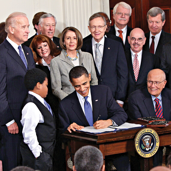 Photo of Barack Obama signing the Affordable Care Act