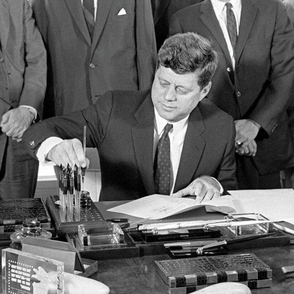 Photo of John F. Kennedy signing a bill