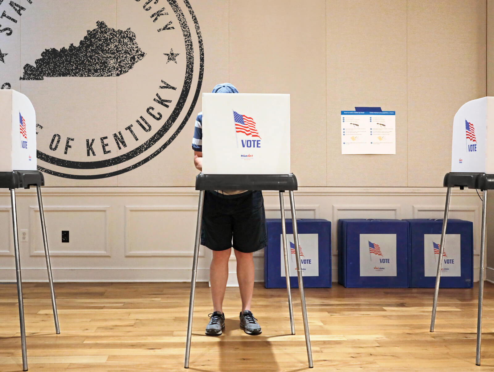 Photo illustration of a person at a voting booth in the state of Kentucky