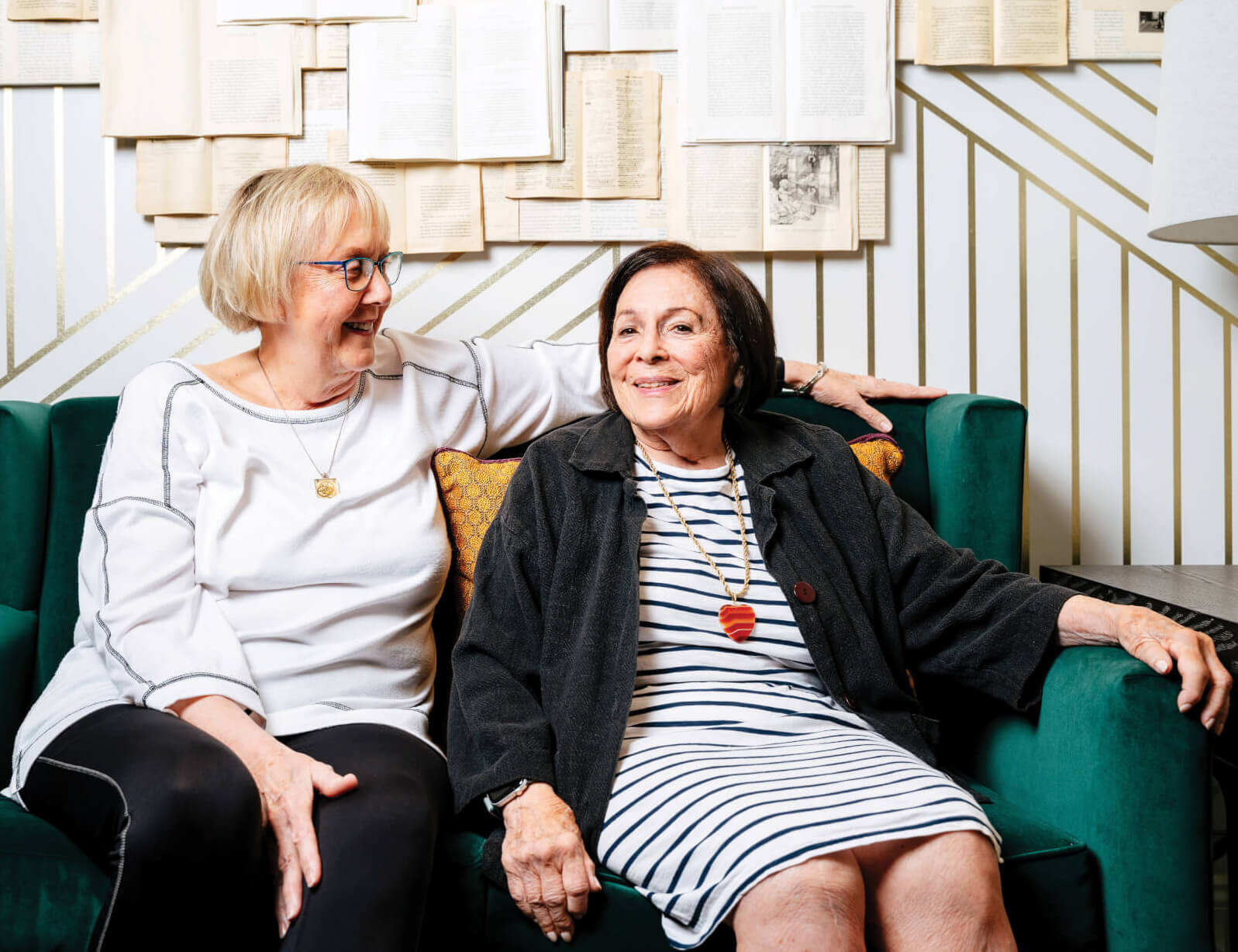 Photo of care companion Donna Gillespie sitting on a couch next to Joanna Edelson