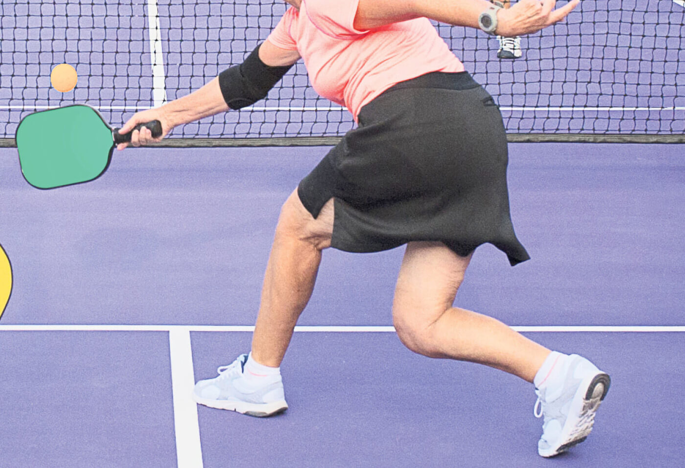 Photo of a woman playing pickleball