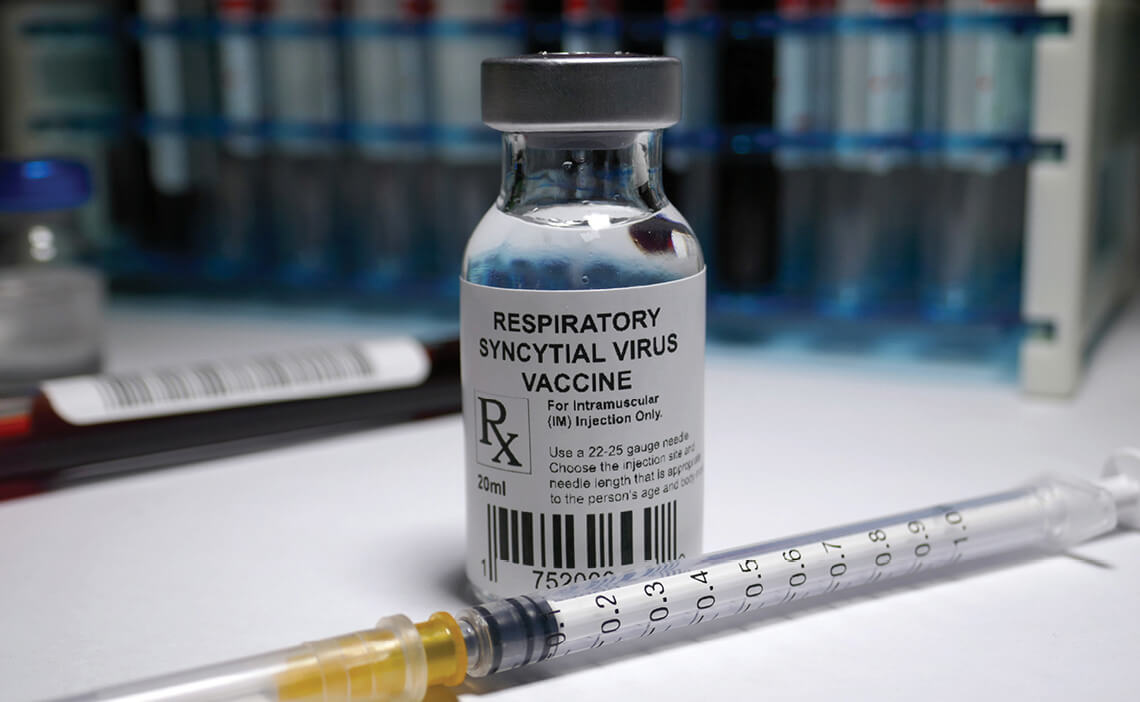 Photo of a vial of a respiratory virus vaccine and a syringe