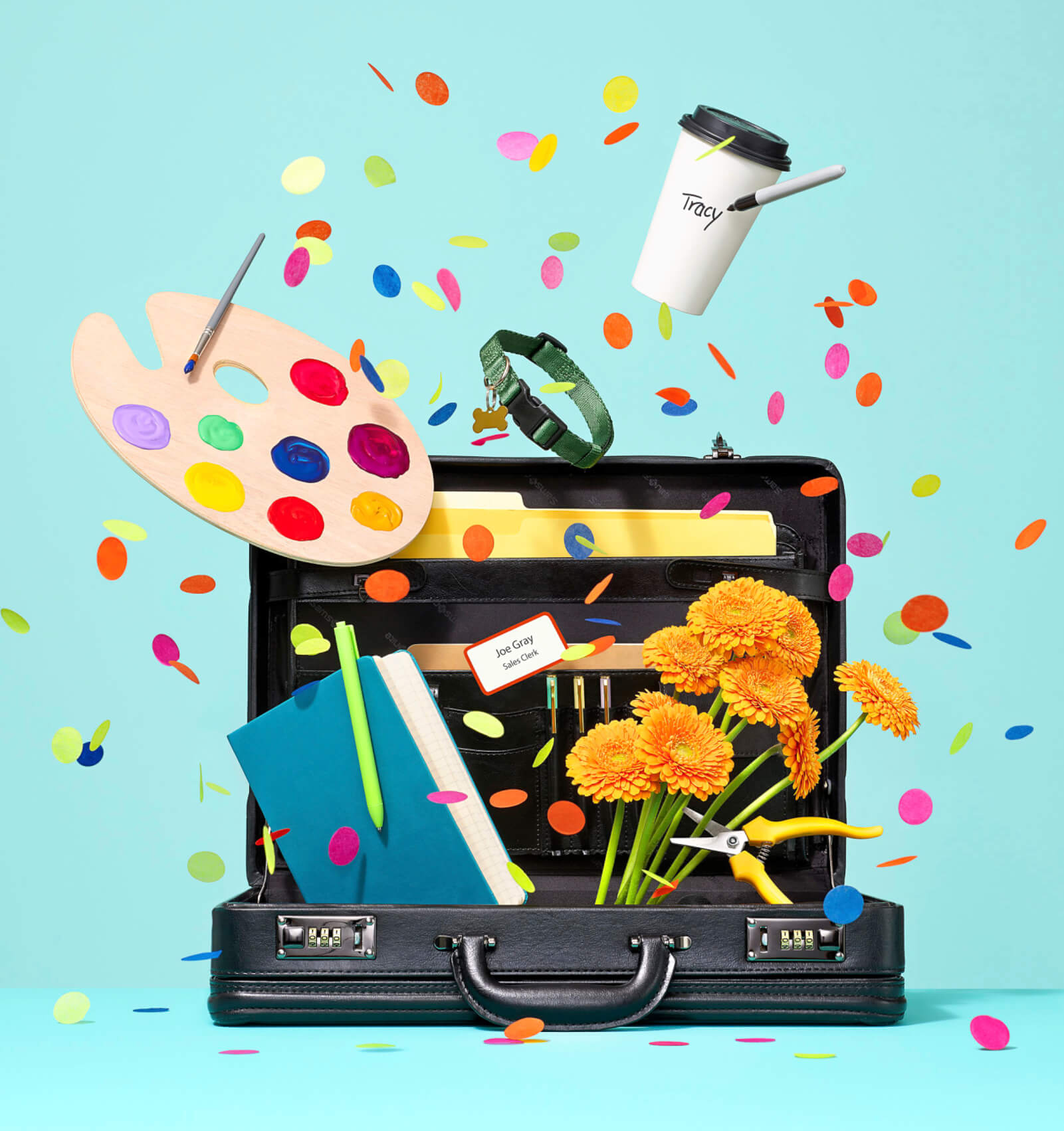 Photo illustration of a black briefcase with various items popping out of it including confetti, flowers and a paint-covered artist's palette