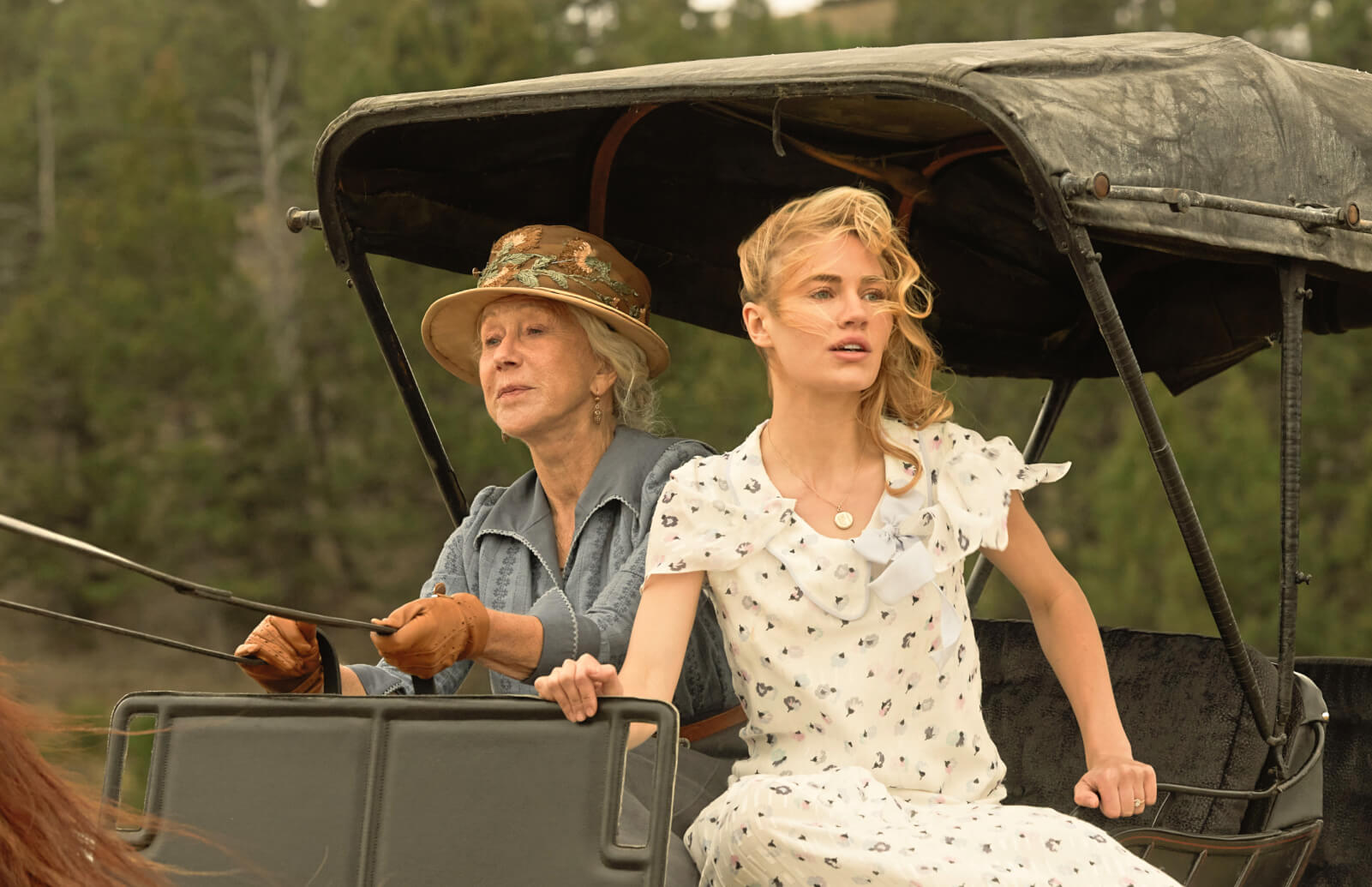 Photo of actors Helen Mirren and Michelle Randolph in a horse carriage on the set of the television series 1923.