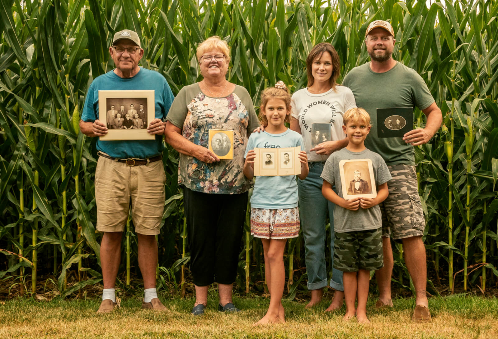 Photo of the Vetter family standing in front of a row of cornstalks