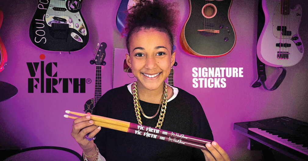 Photo of Nandi Bushell holding a pair of drumsticks