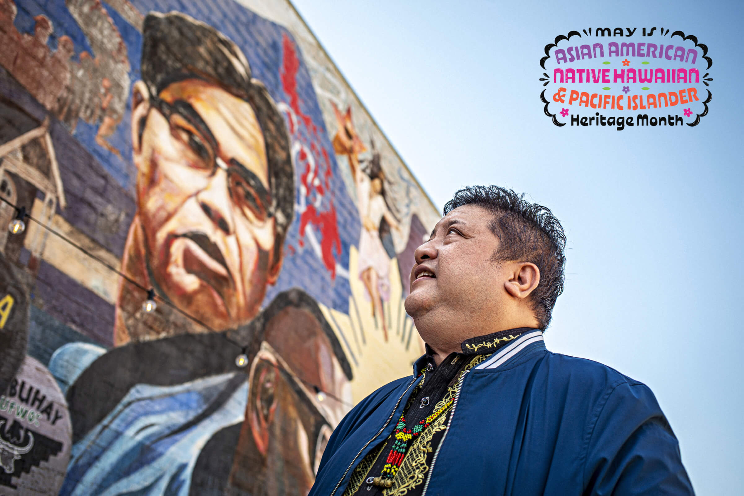 Photo of Eliseo Silva standing in front of his mural