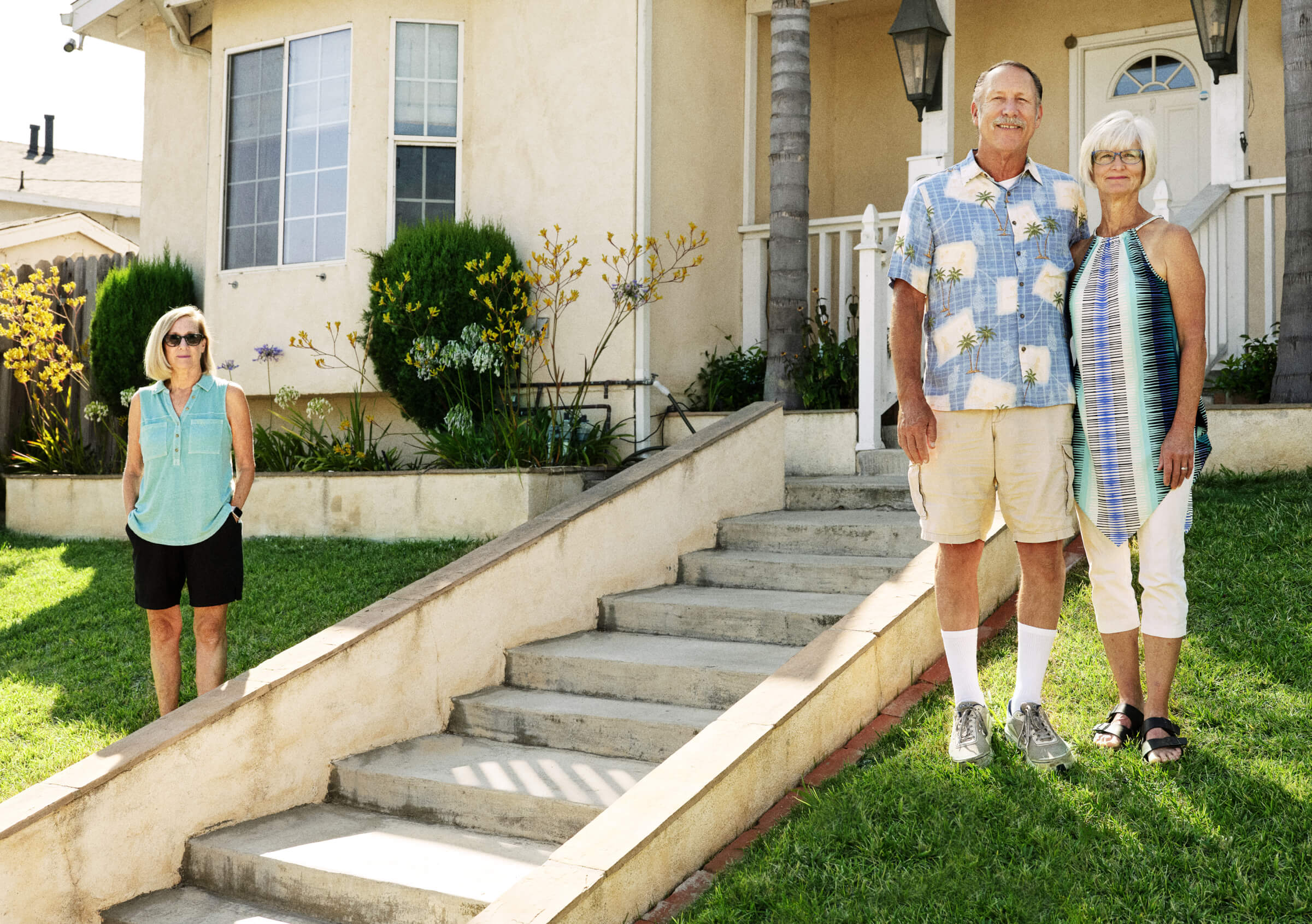 Photo of Lisa, Jon and Tina VanderJagt standing in front of their house