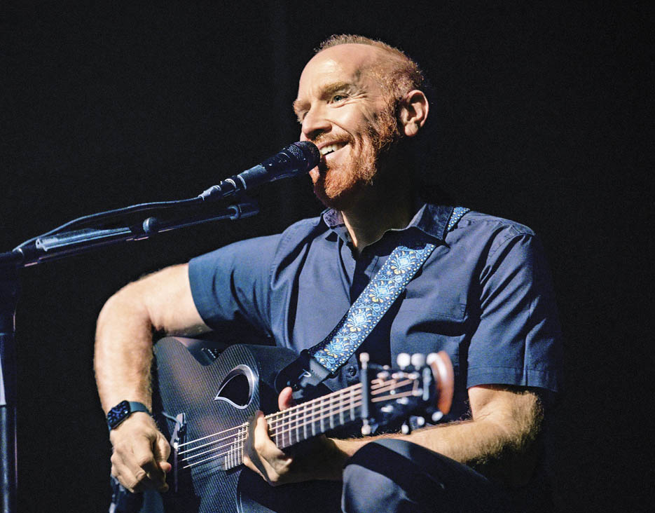 Photo of Mike Massé playing a guitar