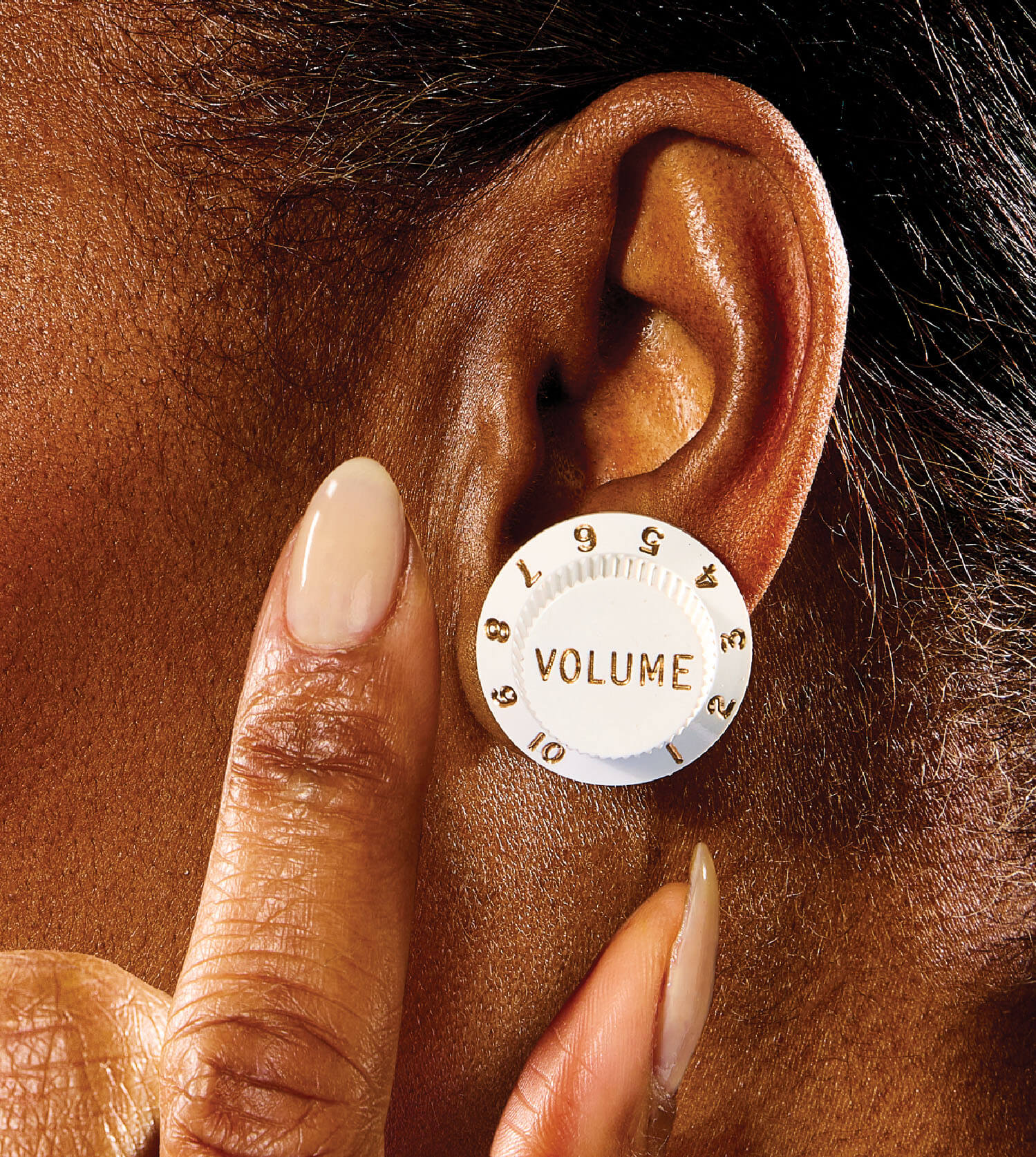 Photo illustration of a woman wearing a volume dial as an earring