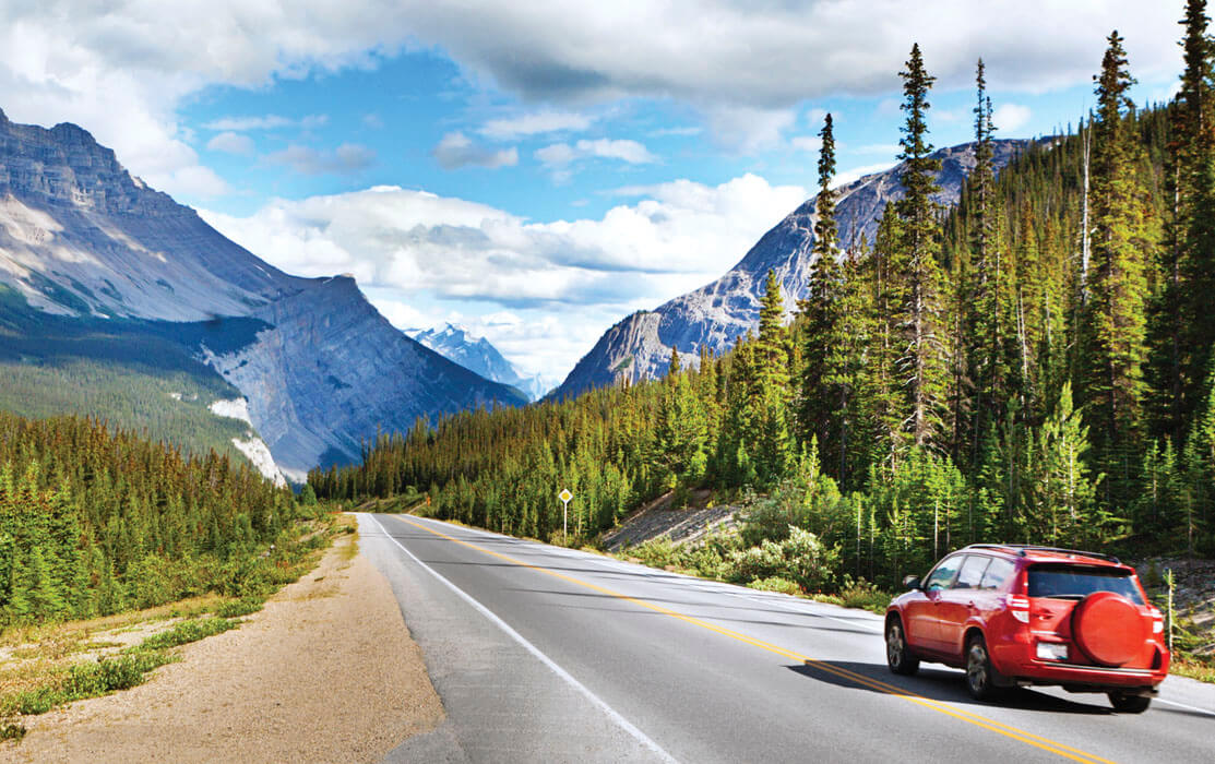 Photo of a car on an open mountain road