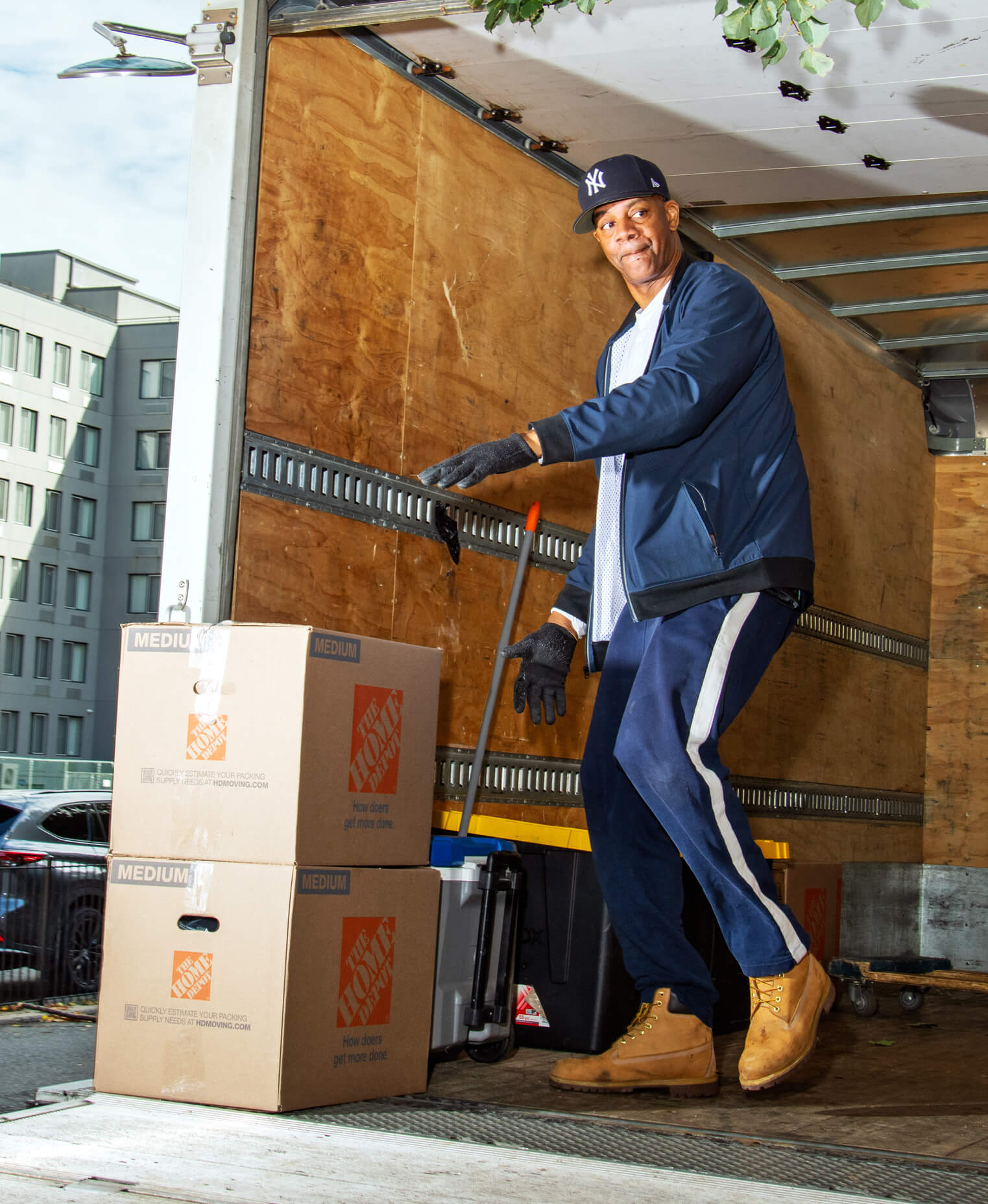 Photo of Adonis Williams unloading boxes out of a moving truck