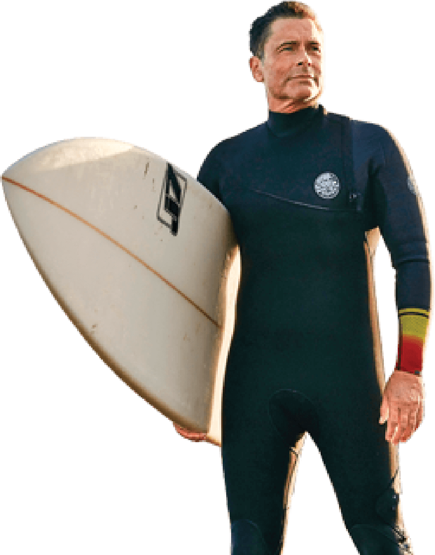Photo of Lowe in wetsuit, holding surfboard
