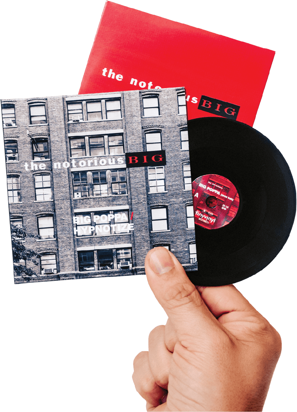 Hand holding up a tiny vinyl