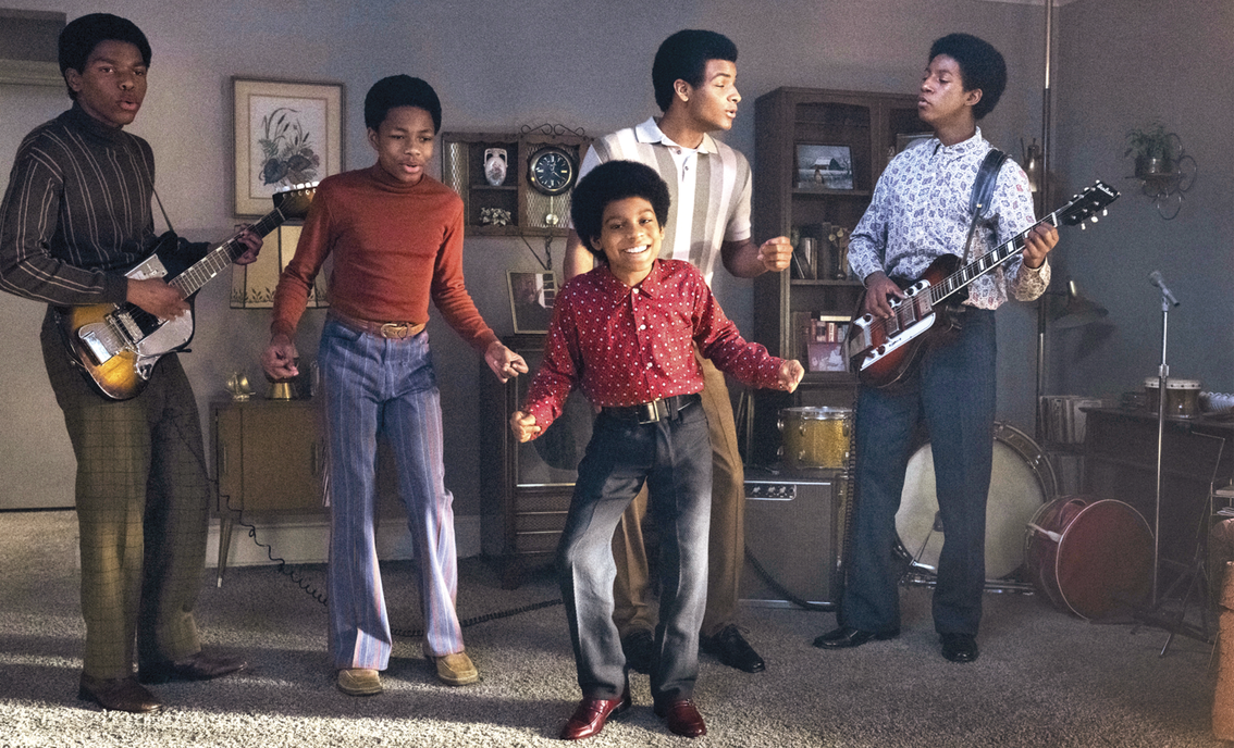Image of young Michael Jackson singing and dancing along with Jackson 5