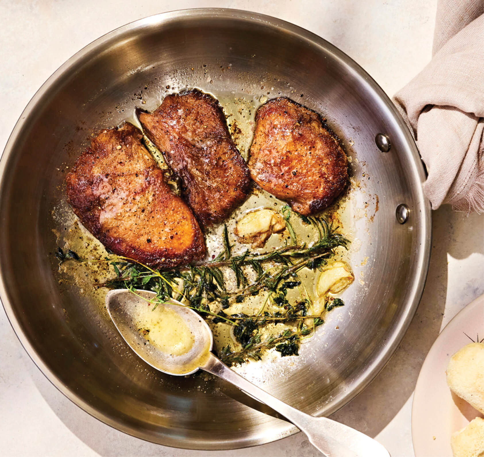 3 slices of a lion’s main mushroom streak cooked in butter and rosemary cooking away in a saucepan