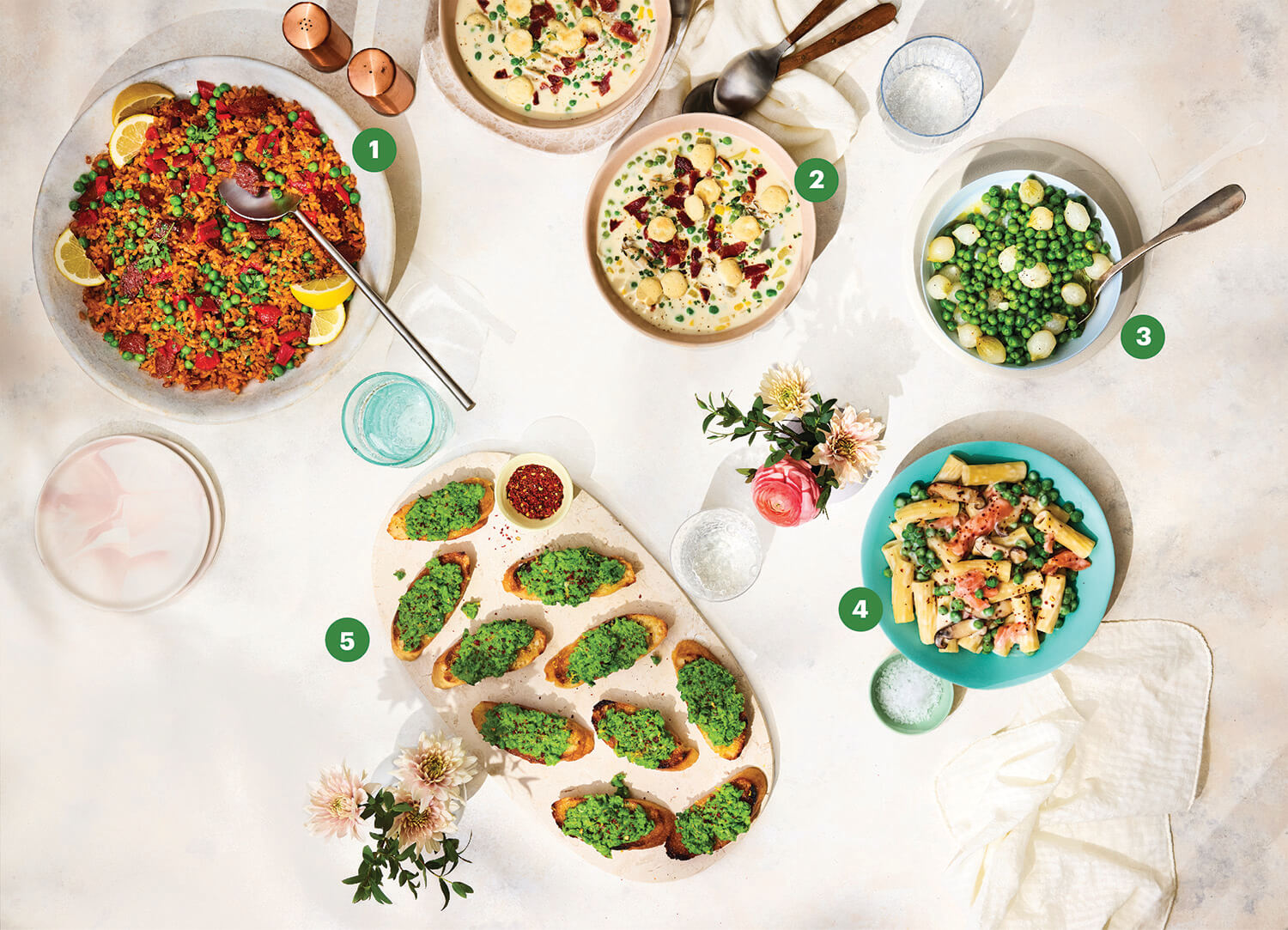 Top view photograph of a table with several dishes made of peas