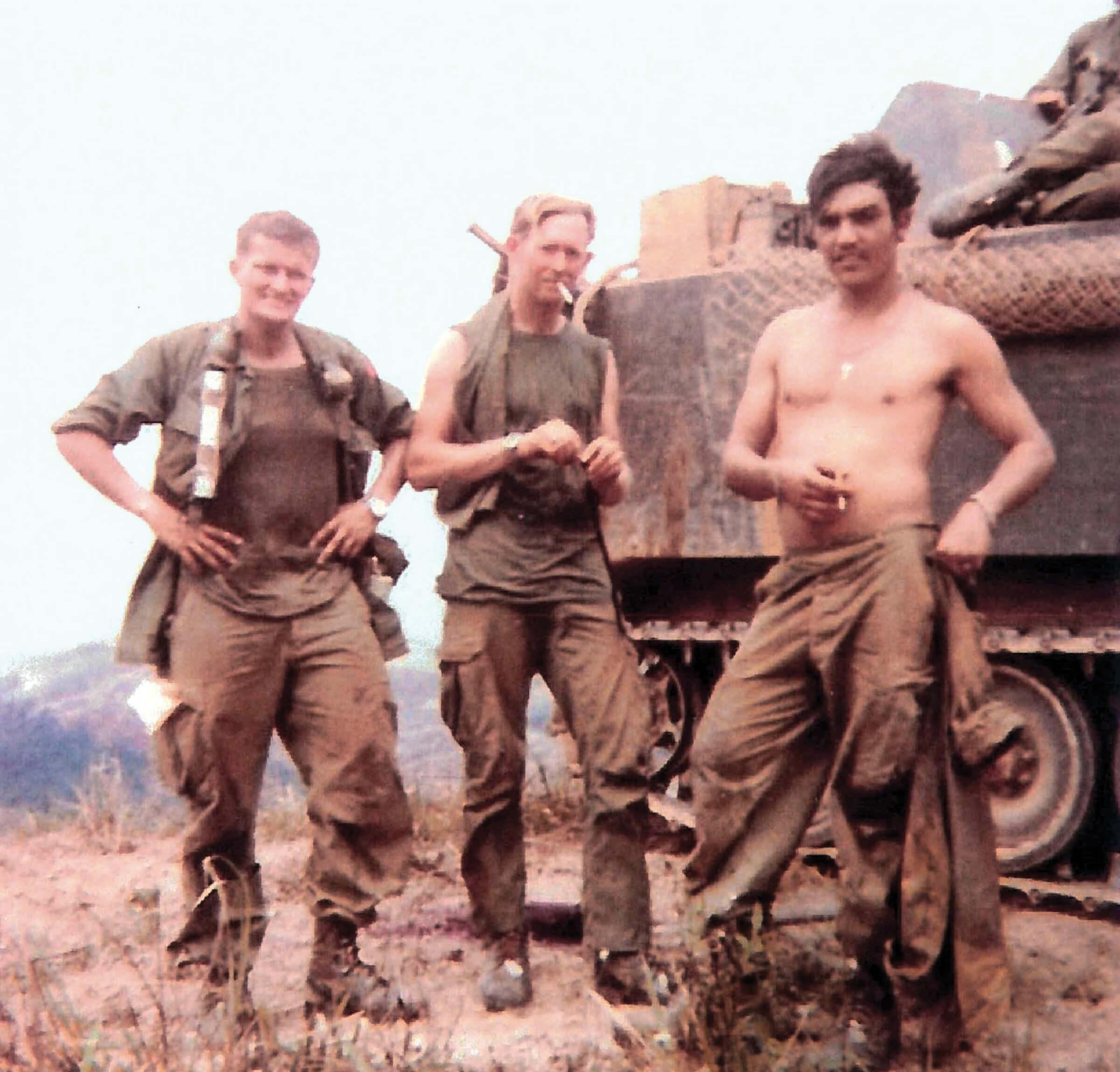 Photograph of Albion Bergstrom and Victor Locke standing in front of a tank, smoking cigarettes 