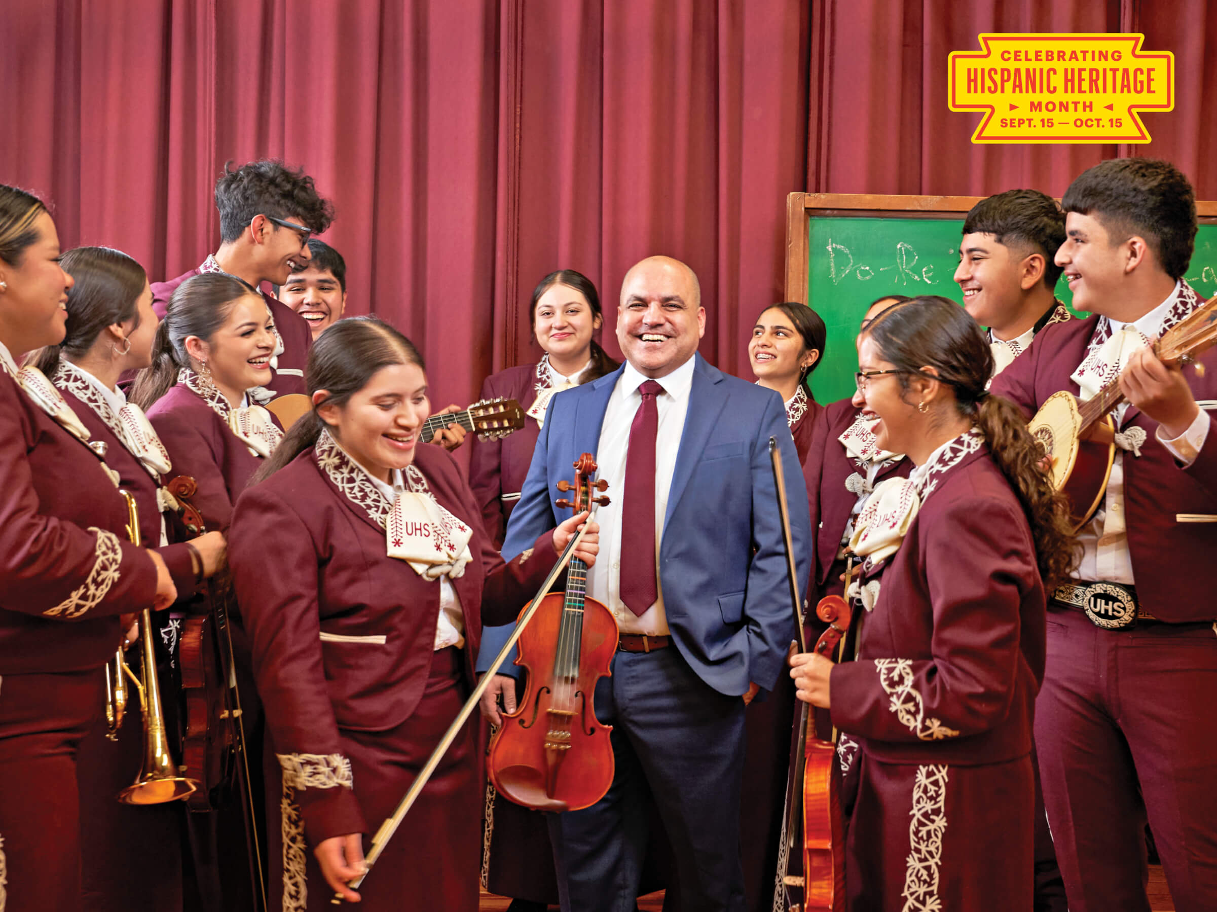 Photo portrait of Albert Martinez surrounded by his Uvalde High School mariachi band