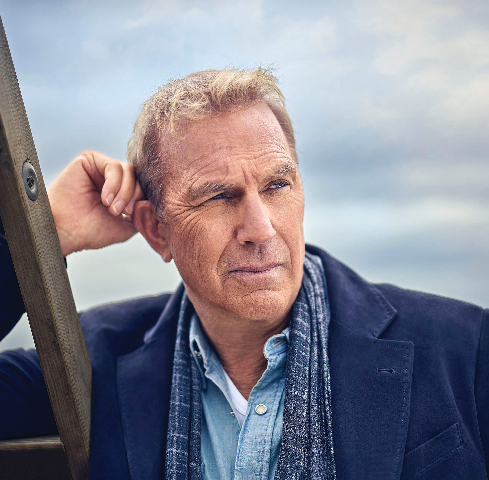 Portrait of Kevin Costner leaning against a ladder