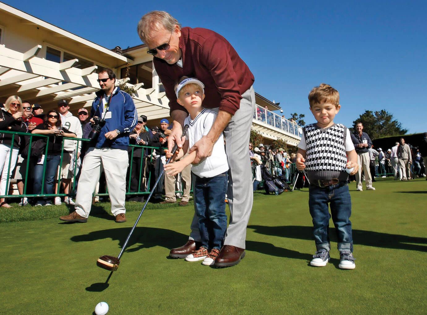 Photo of Costner golfing with his two young sons