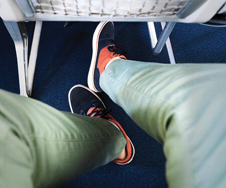 Photo of feet under an airplane seat