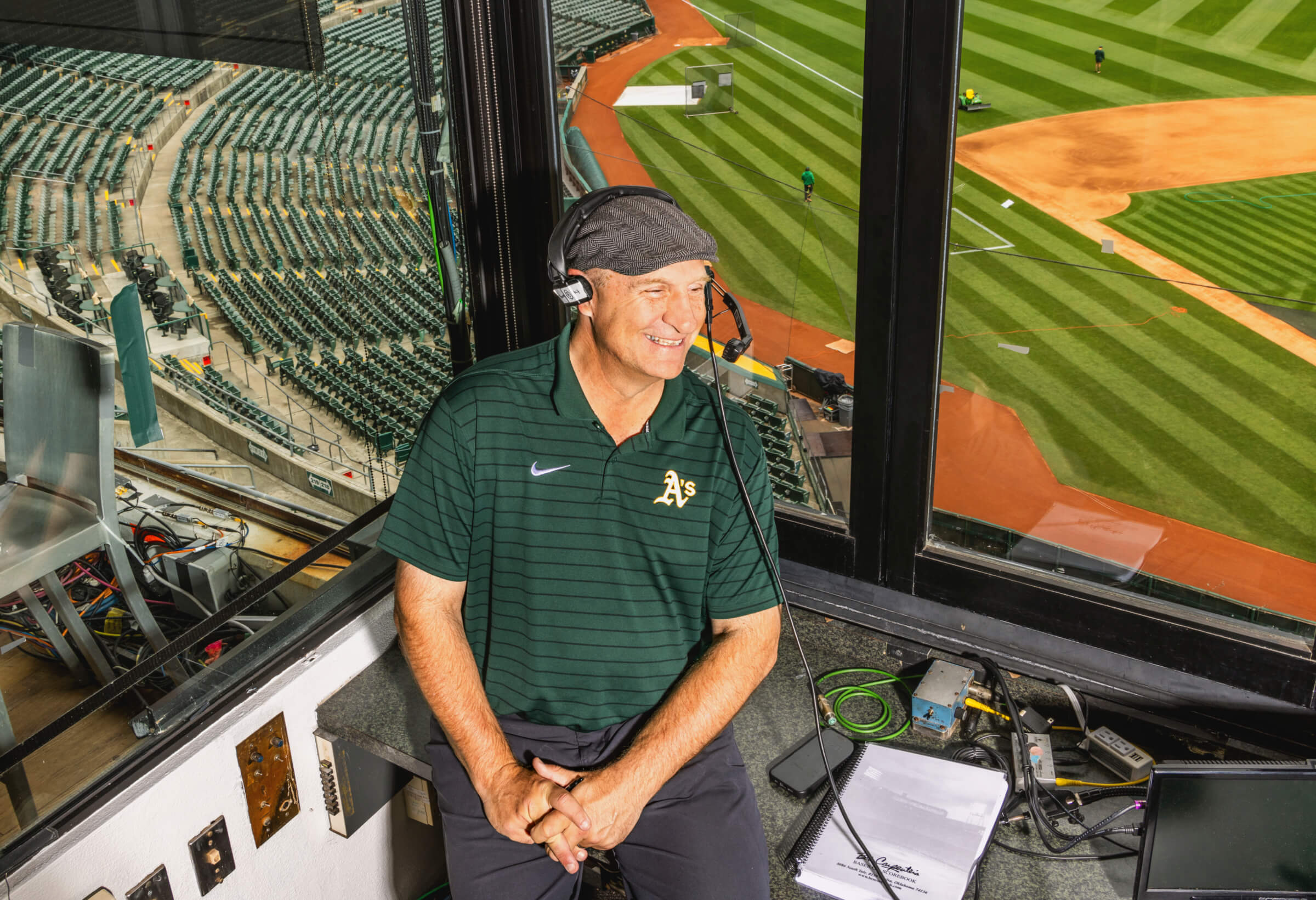 Photo portrait of Johnny Doskow in the play-by-play box at the Oakland Coliseum