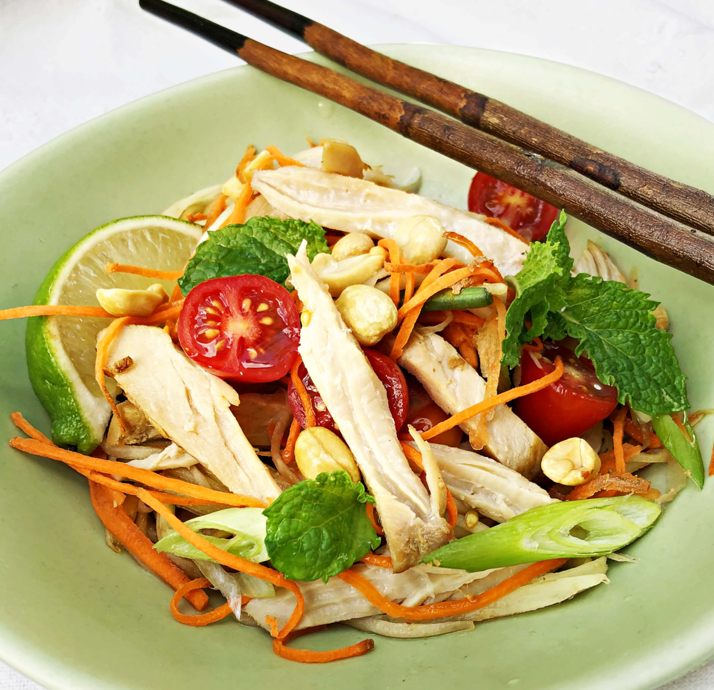 Photo of Asian chicken and green mango salad in a bowl