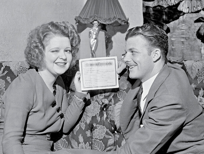 Photo of couple with marriage license