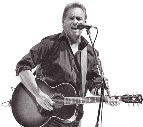 Photo of Costner singing with a guitar