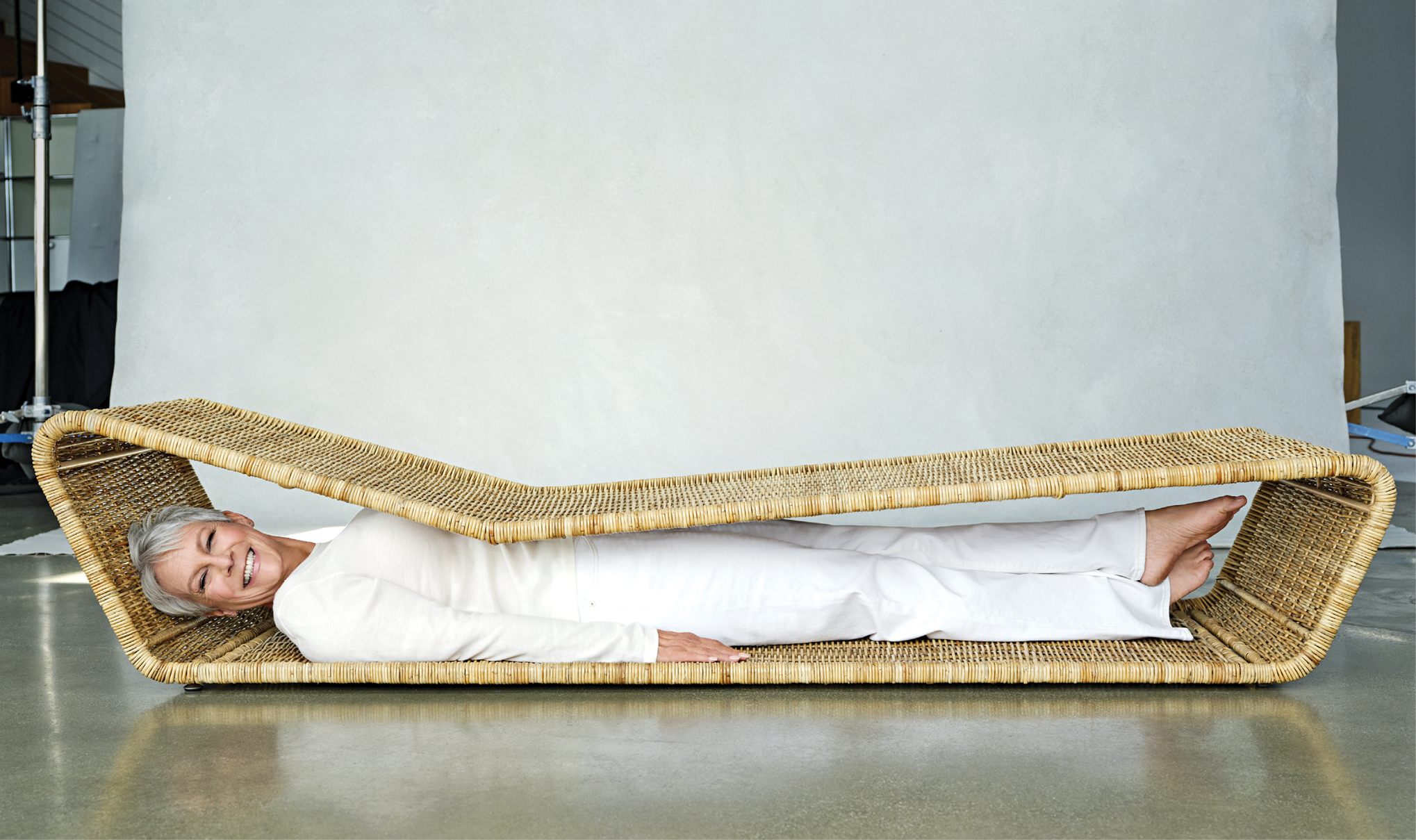Photo portrait of Curtis laying down inside the base of a bench