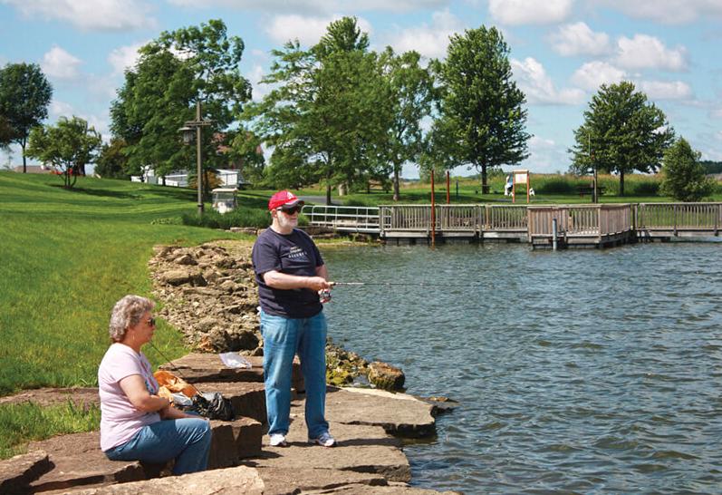 Photo of couple fishing at a pond
