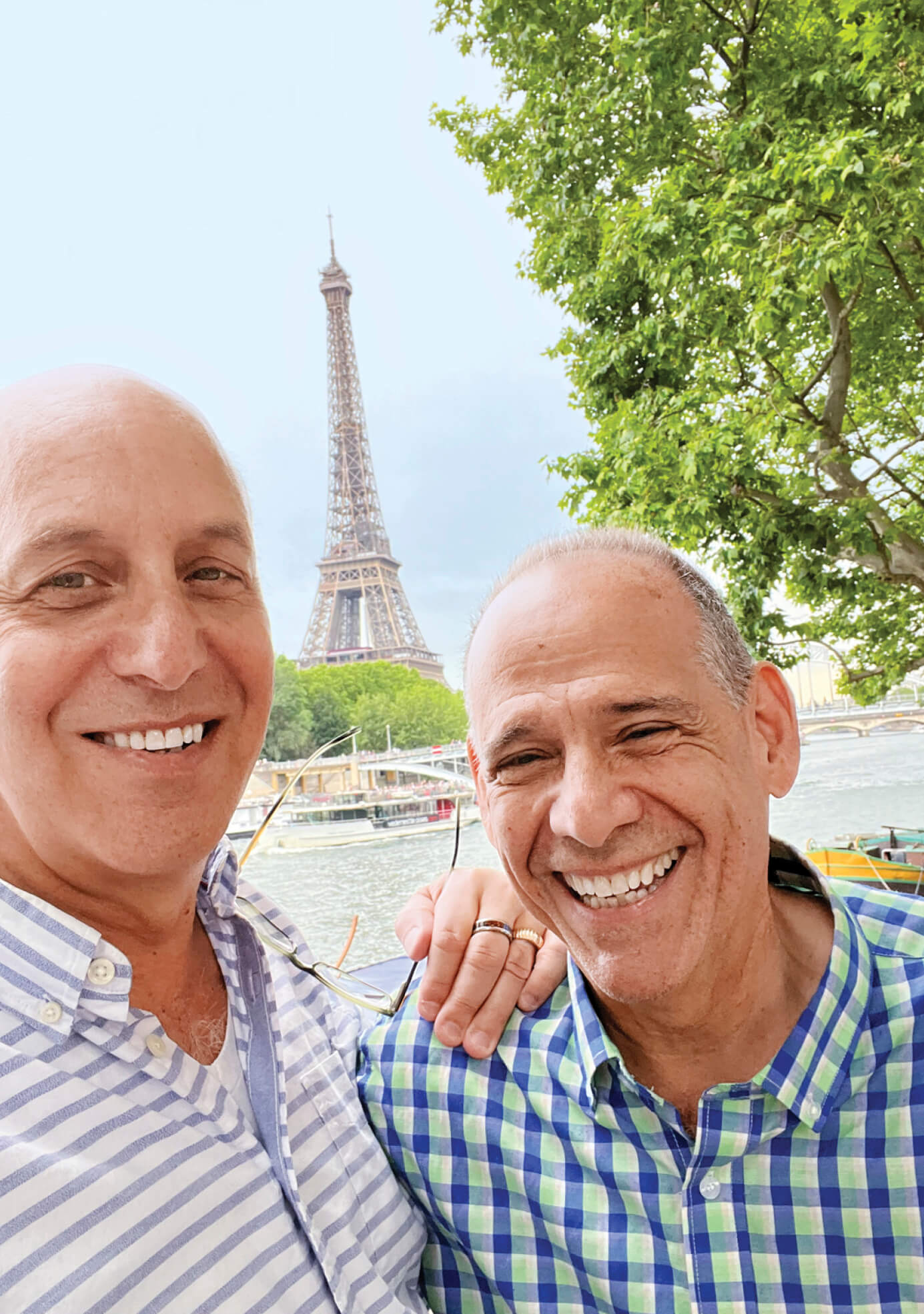 Photo of two men smiling with Eiffel tower in background