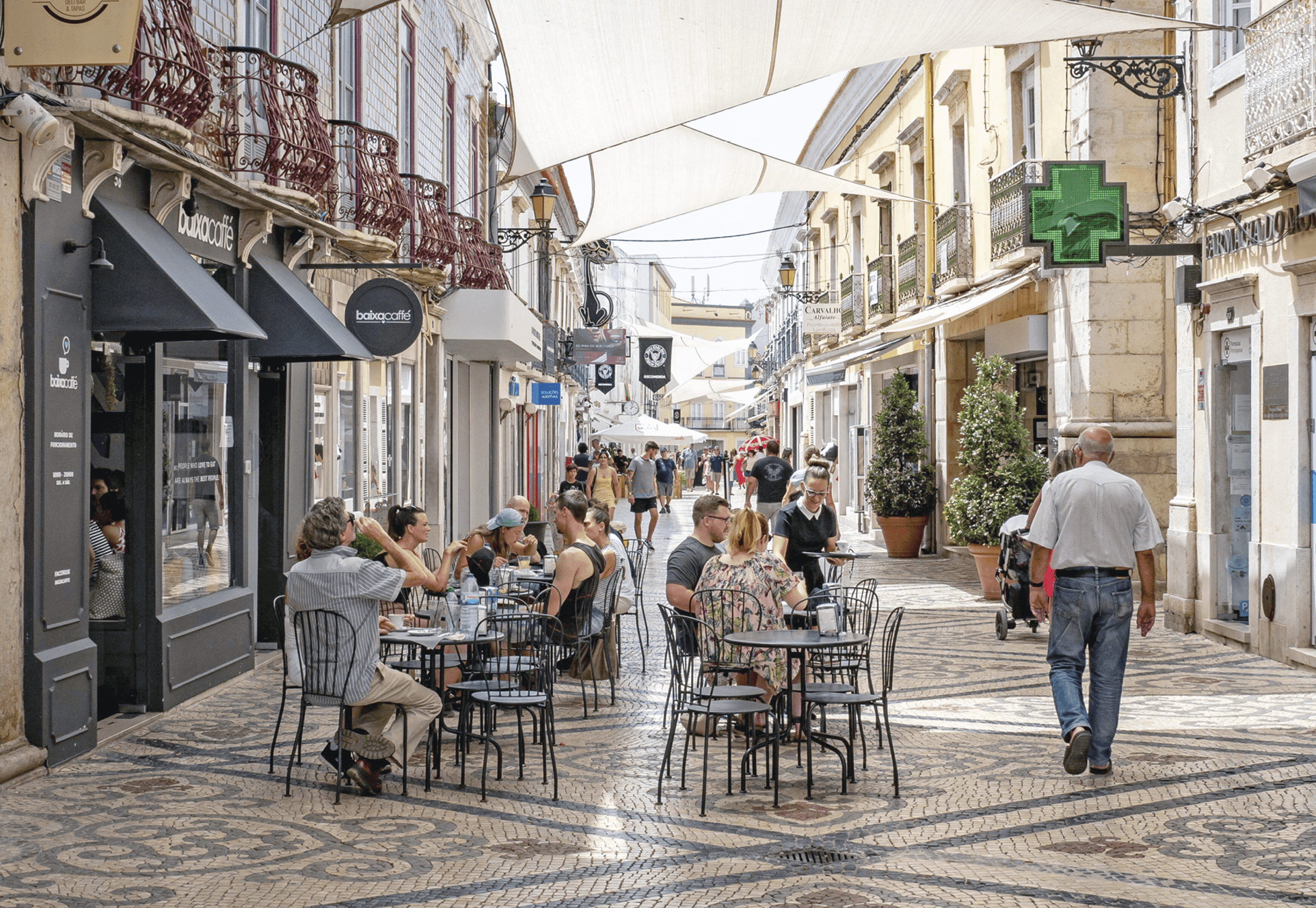 People sitting outside on the streets of Faro Portugal