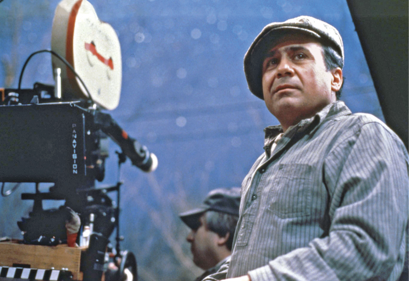 Photograph of Danny DeVito in front of a camera 