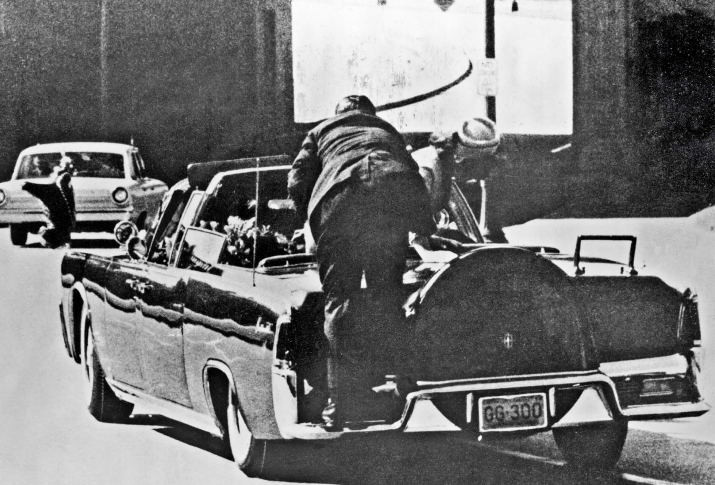 Photo of a secret service agent on the back of JFK's limousine immediately after the assassination in 1963