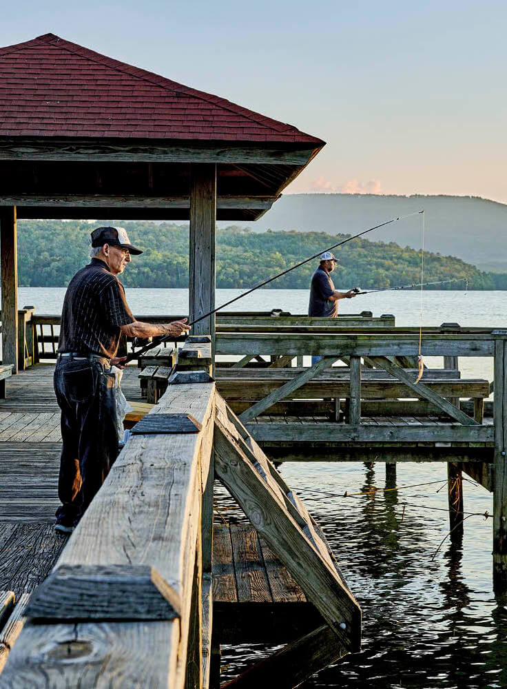 Photo of two men fishing off the dock on Lake Dardanelle in Russellville, Arkansas