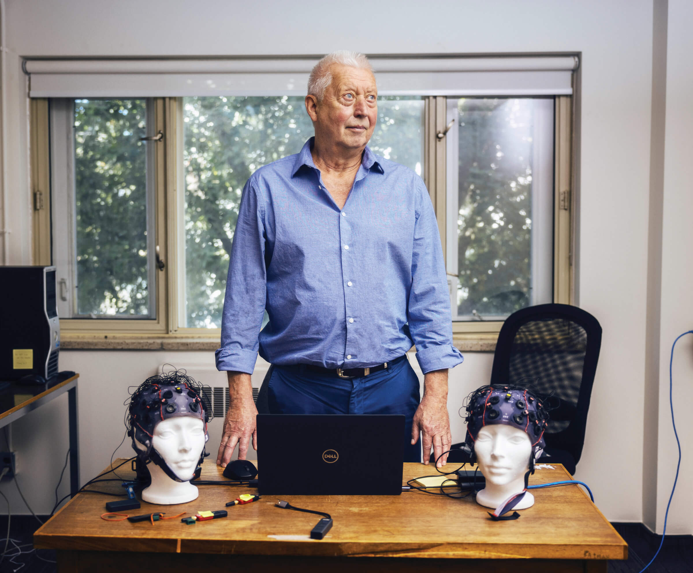 Photo of Michael Thaut standing behind his desk