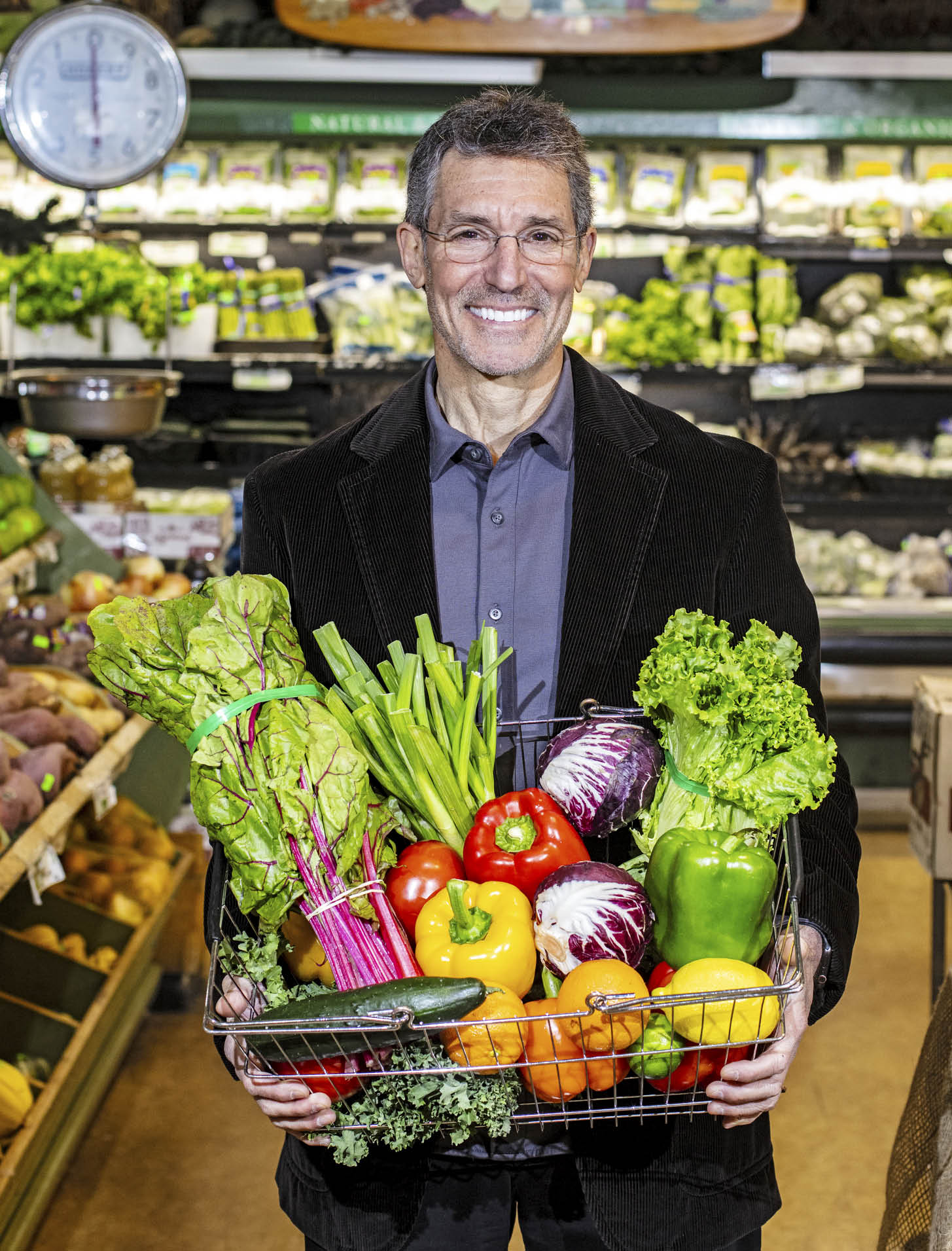 Photo of Dr. David Katz holding a basket full of fresh produce